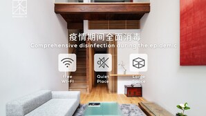 A modern living room with a grey sofa, a wooden coffee table, and a red abstract painting on the wall. - Residence Jo 15 Karasuma shijyo (Kyoto)