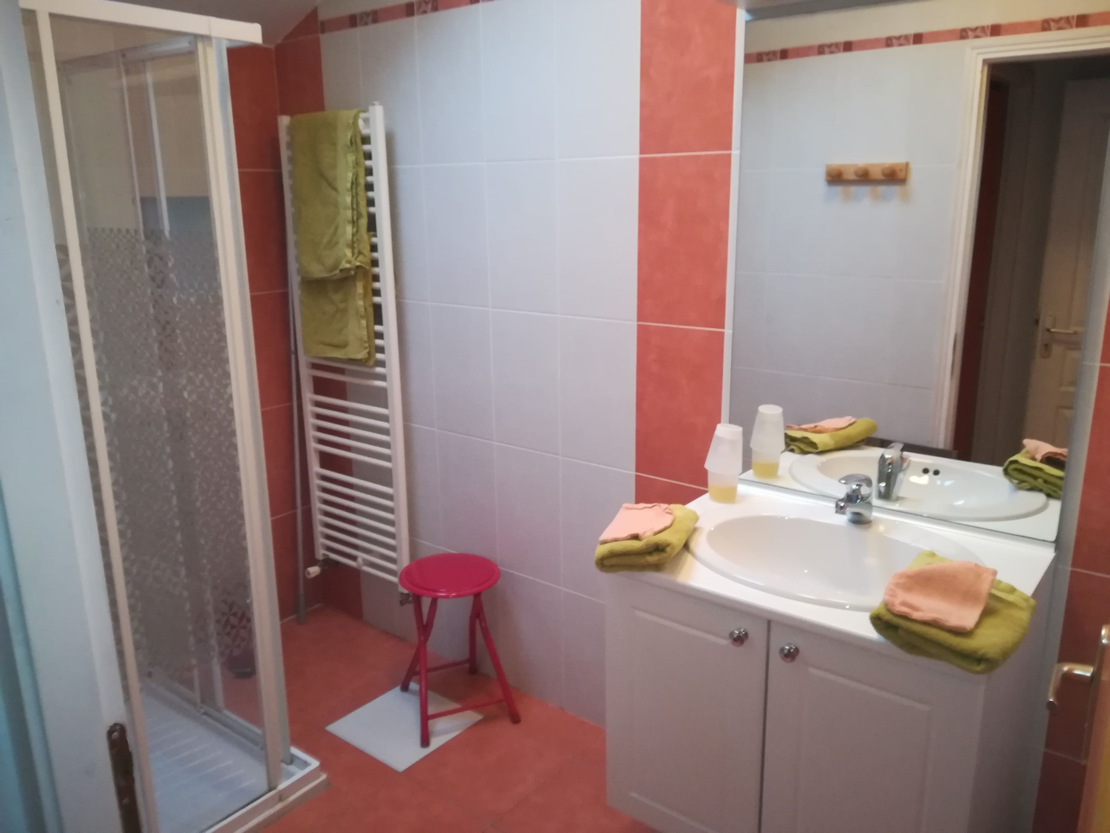 A bathroom with a shower, a sink, and a toilet.