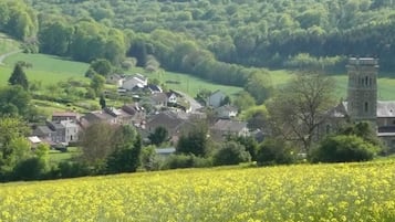 A rural village with houses, a church, and a tower.