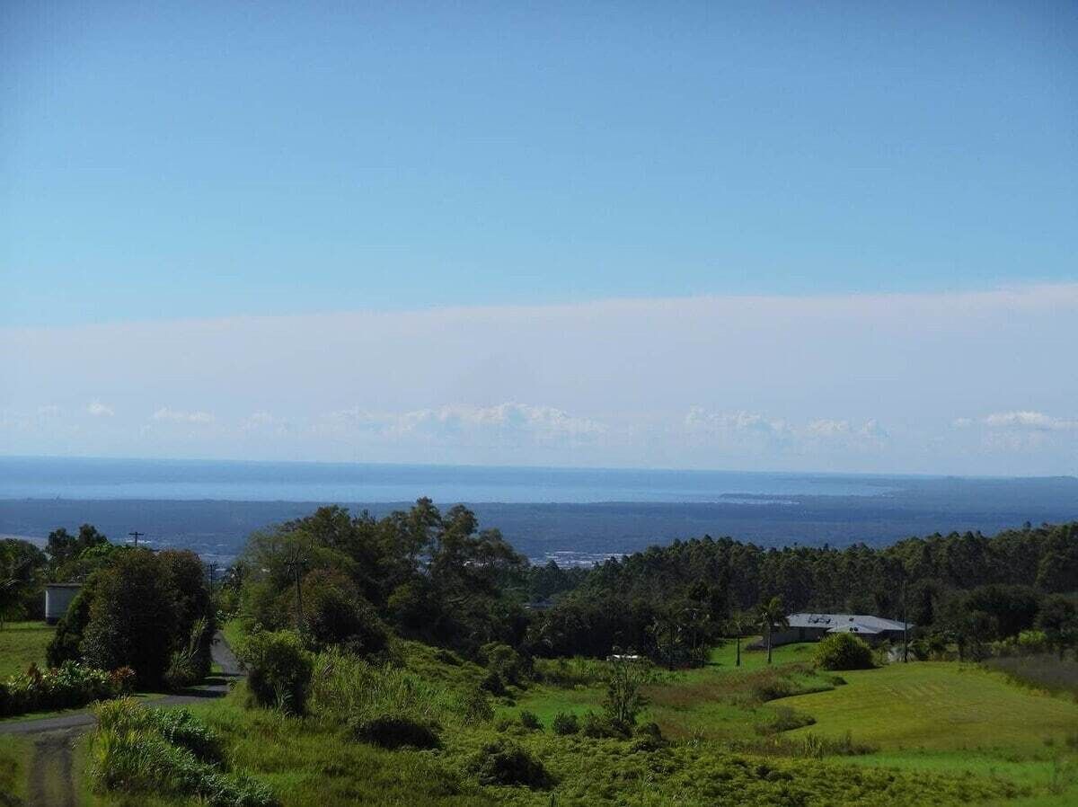 A coastal landscape with a view of the sea and a road leading into the distance.