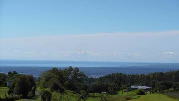 A coastal landscape with a view of the sea and a road leading into the distance.