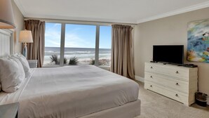 A hotel room with a large bed, a dresser, a television, and a painting. - "Breathtaking Sunsets Await: Recently Renovated 4th-Floor Retreat in Beachside Two!" at Sandestin Golf and Beach Resort! (Miramar)
