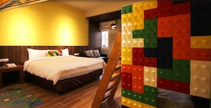 A hotel room with a bed, a nightstand, a wooden floor, and a colorful wall decoration. - Rainbow House (Yuchi)