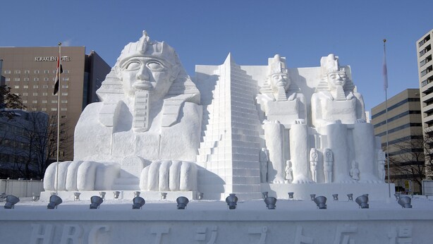 A large snow sculpture of Egyptian pharaohs and pyramids in front of a hotel. - The Base Sapporo Susukino (Sapporo)