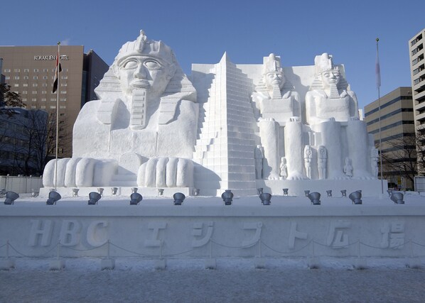 A large snow sculpture of Egyptian pharaohs and pyramids in front of a hotel. - The Base Sapporo Susukino (Sapporo)