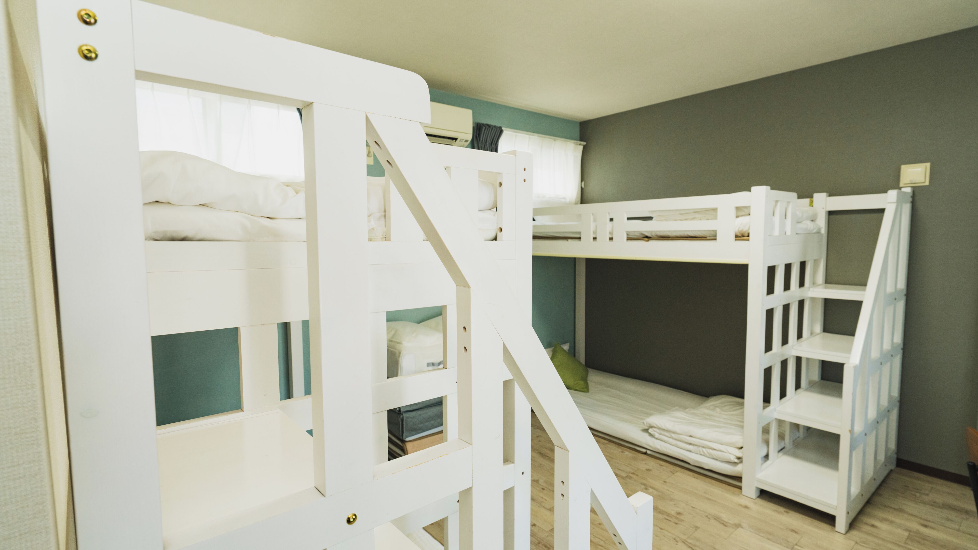 A room with bunk beds and a staircase.