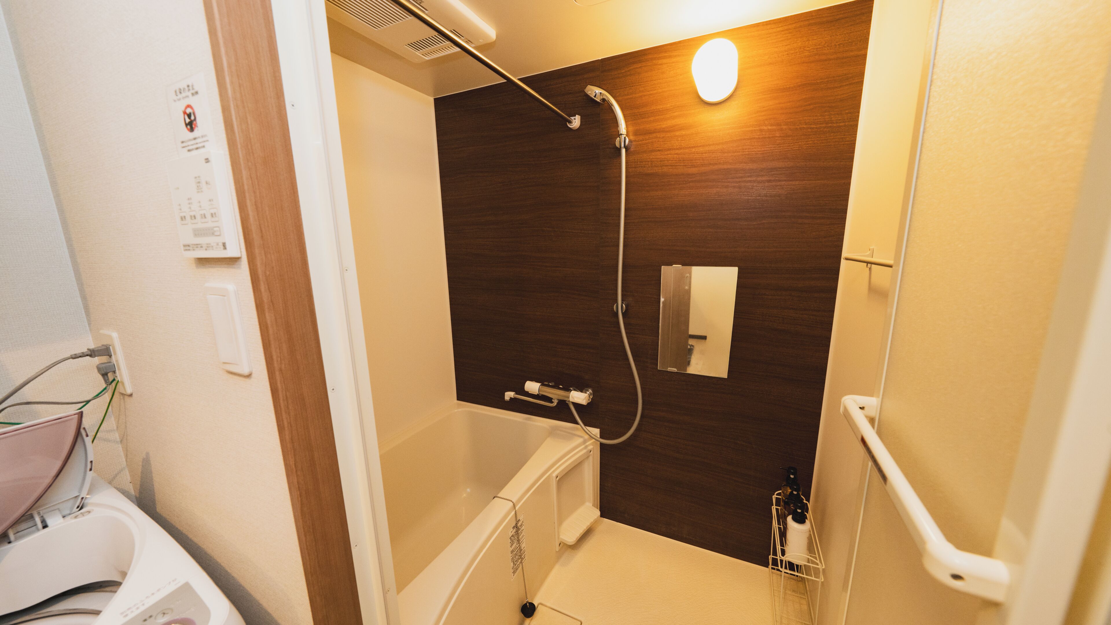 A bathroom with a shower, a toilet, and a sink.