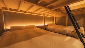 A room with two beds, wooden beams, and a ladder. - The Base Sapporo Susukino (Sapporo)