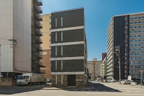 A multi-story building with a modern design, featuring a mix of balconies and windows. - The Base Sapporo Susukino (Sapporo)