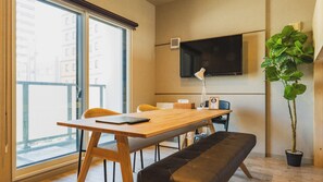 Una habitación moderna con una mesa de madera, un banco y una planta en maceta.