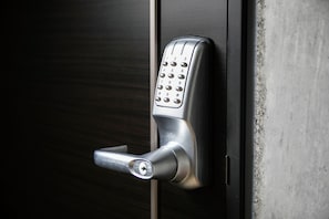 A modern door lock with a numeric keypad and a keyhole. - The Base Sapporo Susukino (Sapporo)