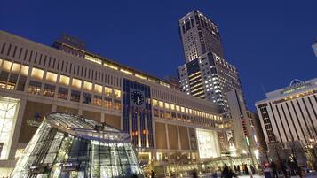 A modern building with a prominent clock tower and a glass atrium.