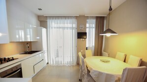 Apartment | Private kitchen | Full-size fridge, stovetop, electric kettle, cookware/dishes/utensils - Hosthub - Apartment at Janashia str (Tbilisi)