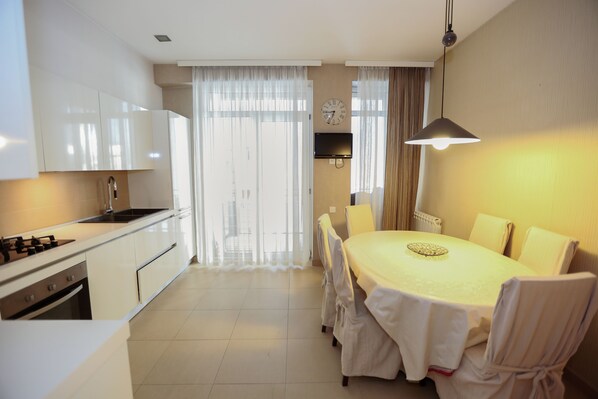 Apartment | Private kitchen | Full-size fridge, stovetop, electric kettle, cookware/dishes/utensils