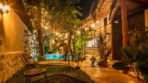 An outdoor pool area with seating and potted plants. - Hotel Boutique TerraNova (Tulum)