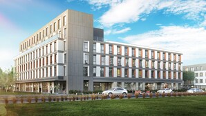 A modern multi-story building with a flat roof, large windows, and a parking area with cars. - Arche Hotel Poloneza (Warsaw)