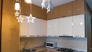Apartment | Private kitchenette | Fridge, microwave, oven, stovetop - HostHub Studio Apartment in the center (Tbilisi)