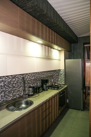 Apartment | Private kitchen | Full-sized fridge, oven, stovetop, electric kettle - Hosthub 9 Ana Politkovskaia Street (Tbilisi)