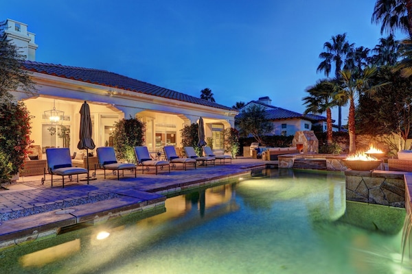 Private, resort-style backyard with fireplace, custom BBQ island, ample seating and al fresco dining.