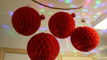Red paper lanterns hanging from a branch.