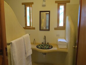 A bathroom with a sink, mirror, and two windows. - Villa Gardenia - Casa Cactus by the sea (Todos Santos)