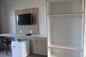 A modern kitchenette with a built-in microwave, a small refrigerator, and a flat-screen TV mounted on the wall. - Locanda Dei Venti (Itarema)