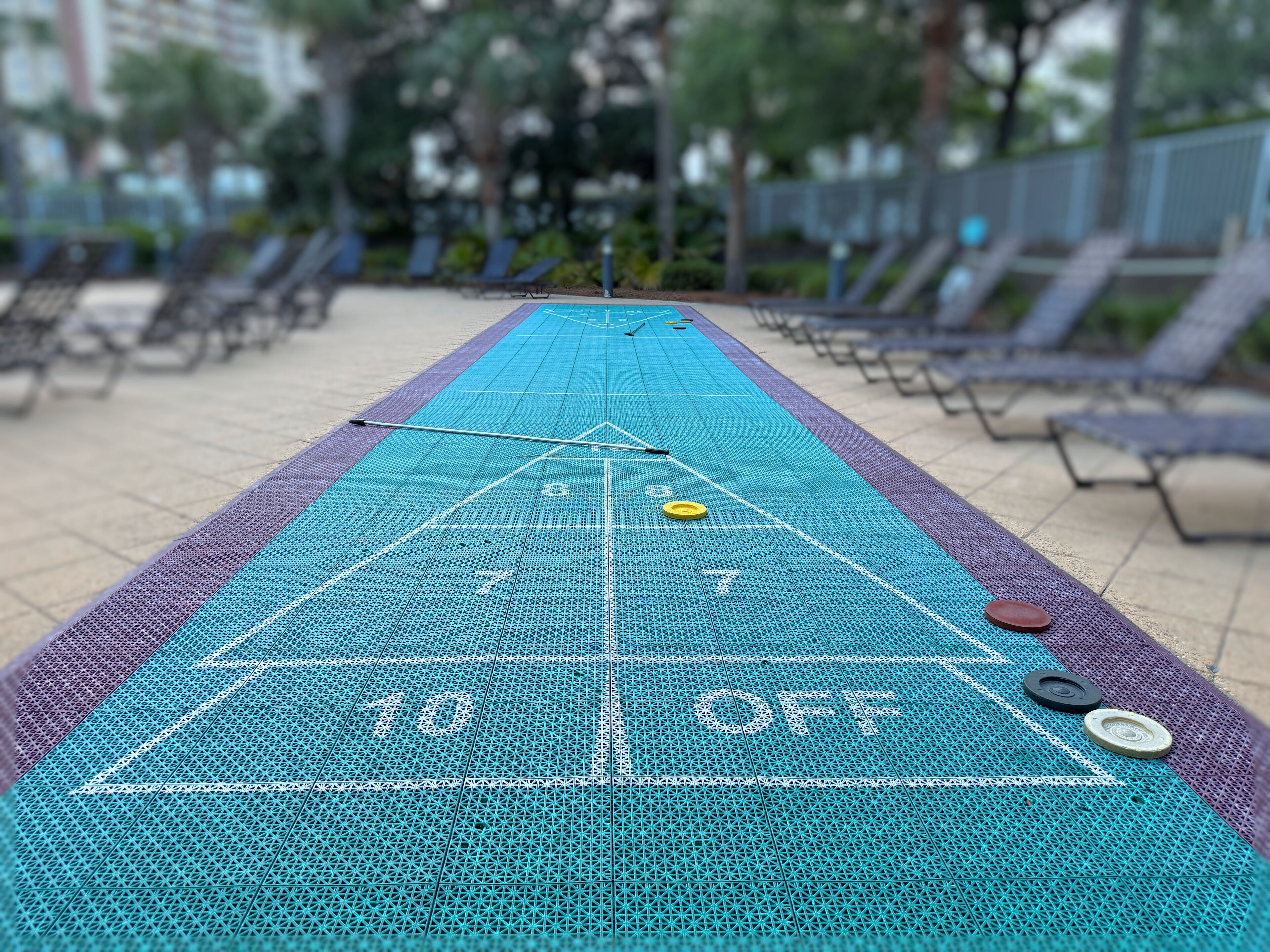 A shuffleboard table with numbered scoring areas and a 'OFF' zone.