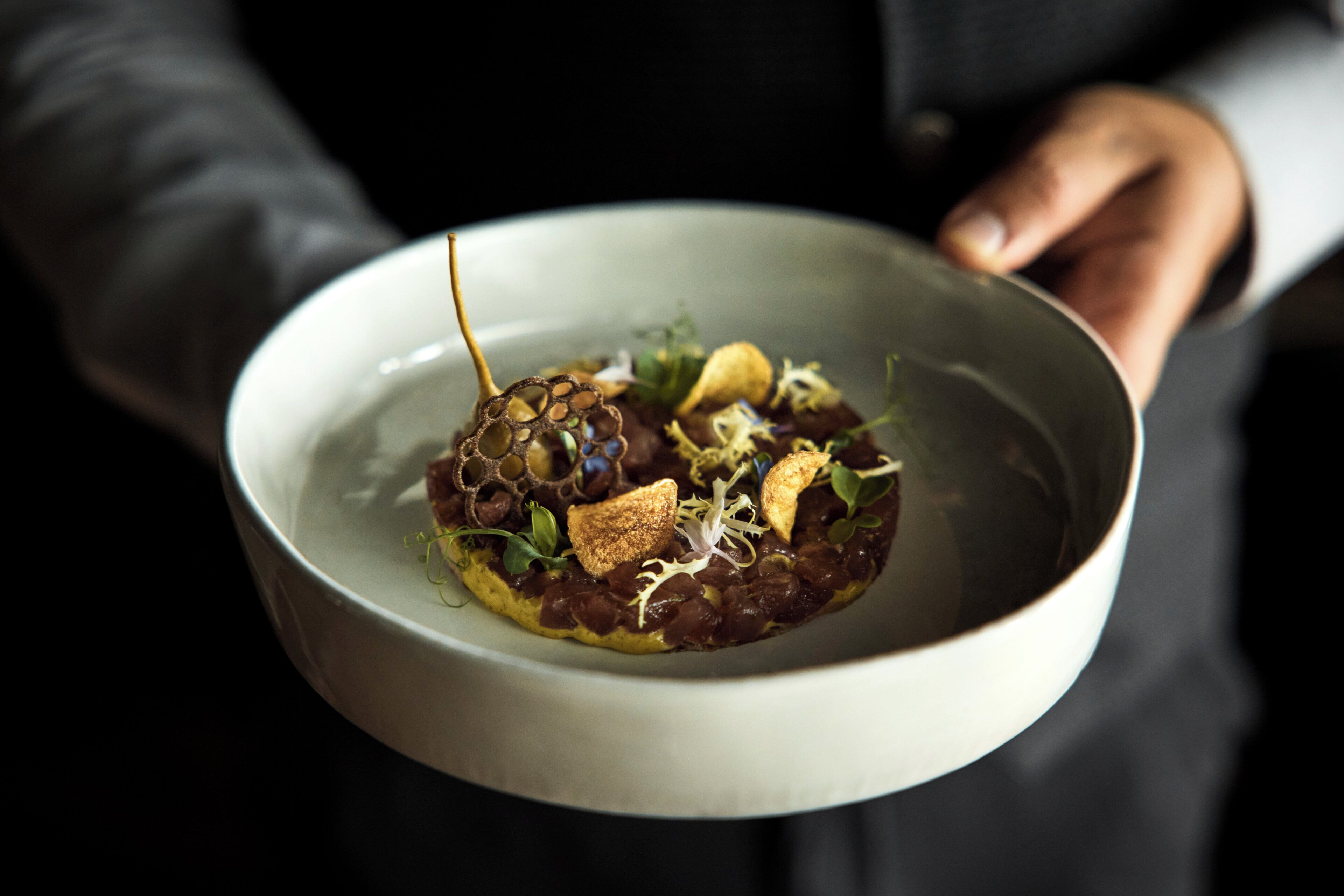 A person holding a bowl of food.