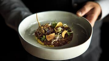 A person holding a bowl of food.