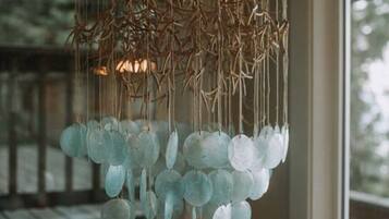 A chandelier with a unique design featuring hanging branches and spherical glass elements.