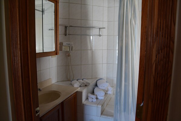 A bathroom with a wooden vanity, a mirror, a towel rack, and a shower curtain. - Perfect For Wedding Guest, Friends Getaway Or Family Vacation (Middletown)