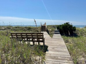 On the beach, beach umbrellas - Experience oceanfront luxury at Serenity's Star, a spacious 4BR home in Holden Beach. (Holden Beach)