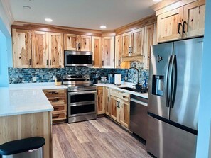 Fridge, microwave, oven, stovetop - Experience oceanfront luxury at Serenity's Star, a spacious 4BR home in Holden Beach. (Holden Beach)