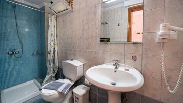 Shower, hair dryer, towels, toilet paper