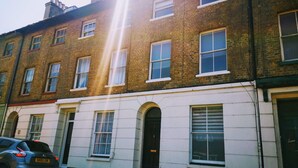 A row of terraced houses with white facades and multiple windows. - Dover Town Rooms (Dover)