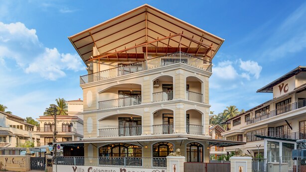 A multi-story building with balconies and a covered upper level, labeled "Villa Calangute Resort." - 10 Bedroom Private Pool Villa in Calangute with Jacuzzi, Kids Pool, Mini Golf (Calangute)