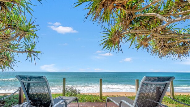 Two lounge chairs facing a beach with a clear view of the ocean. - Luxury condo, ocean views, sea breeze, pool, tennis court, minutes to cafes (Sapphire Beach)