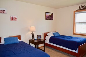 A hotel room with two single beds, a nightstand with a lamp, a framed picture on the wall, and a window with a view. - Stunning view of Lake Pepin! 1/2 mile to Villa Bellezza (Pepin)