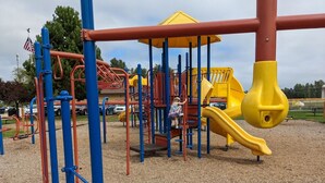 A playground with a yellow slide and climbing structures. - Sequim Lavender Castle (Sequim)