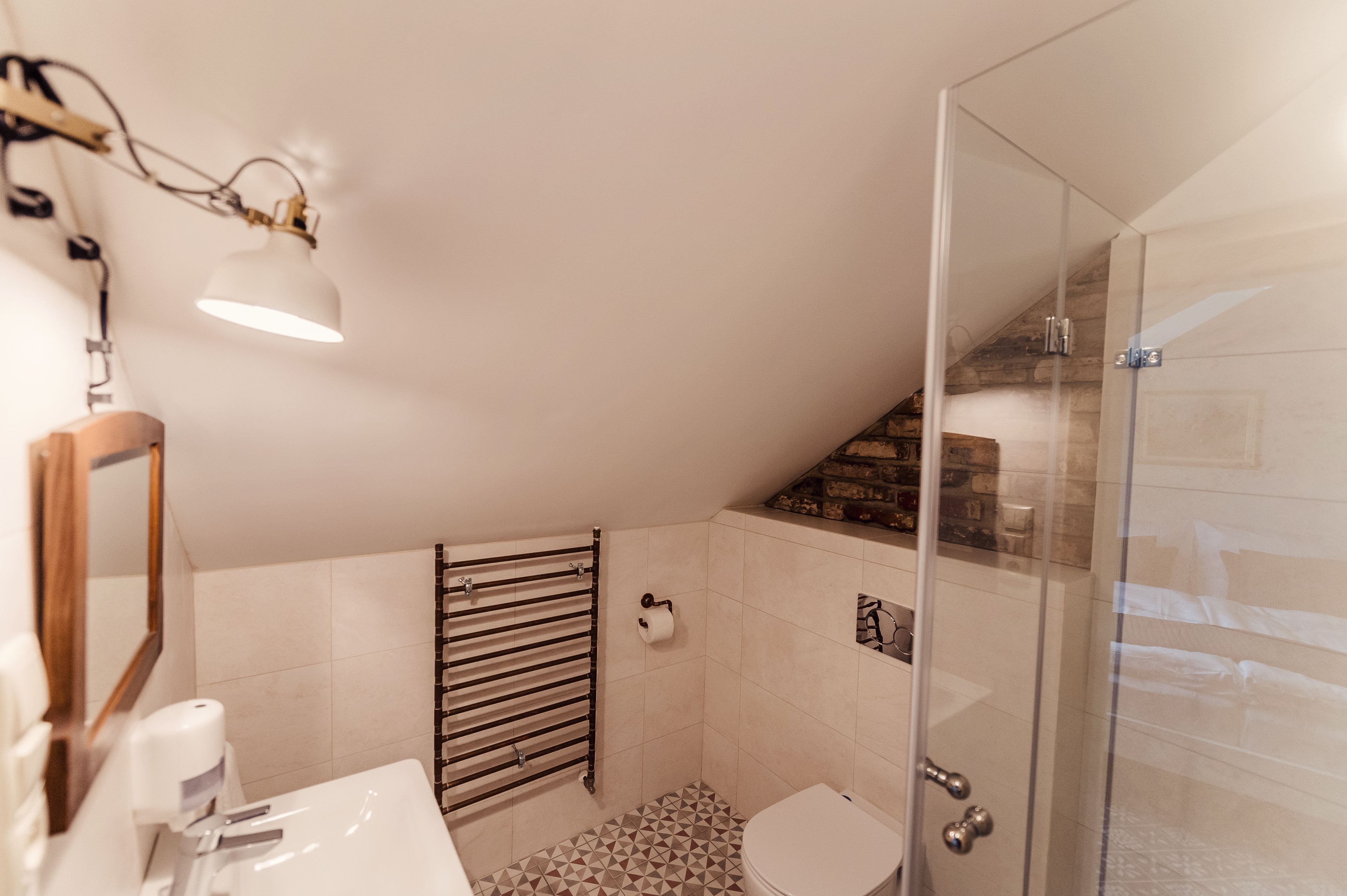A modern bathroom with a shower, toilet, and sink.