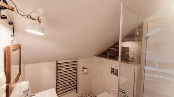 A modern bathroom with a shower, toilet, and sink.