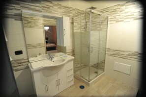 Shower, rainfall showerhead, bidet, towels