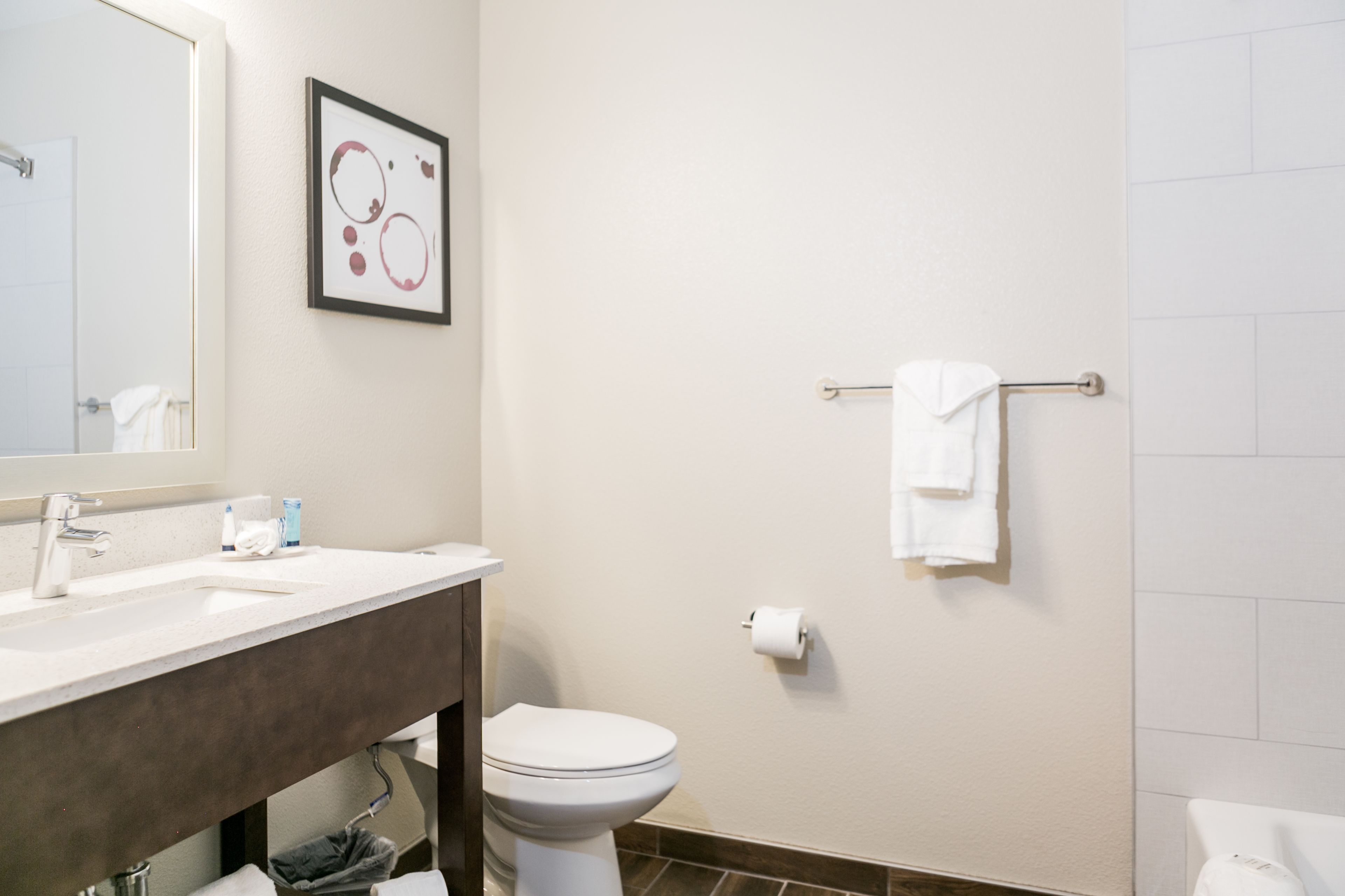 A bathroom with a white sink, a toilet, and a towel rack.