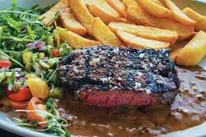 A plate with a steak, fries, and a salad. - Waterfront Lodge 4 with Hot Tub (Kentallen Pier)