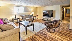 A living room with a sofa, coffee table, and a TV. - Lakefront Fairbanks Unit, 1 Mile to Pioneer Park! (Fairbanks)