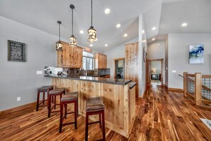 Enjoy cooking in this well-equipped kitchen with a central island and bar seating area.