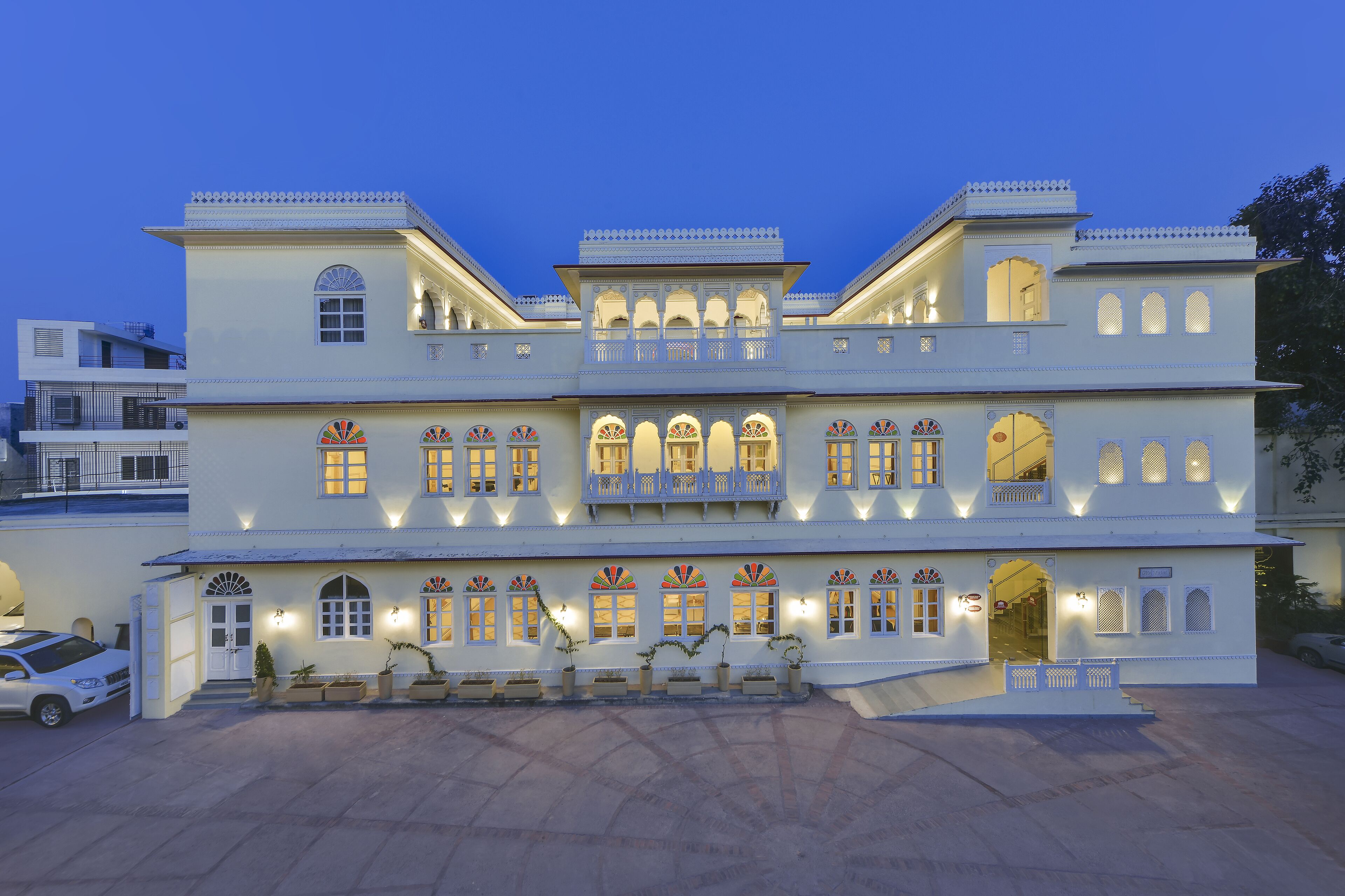 A multi-story building with traditional architecture, featuring arched windows and balconies.