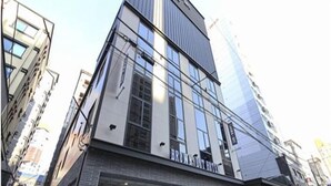 Un edificio moderno con fachada de vidrio y un letrero que dice "BROWN'S BOUTIQUE".