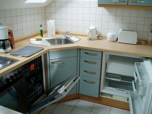 Fridge, stovetop, dishwasher, coffee/tea maker