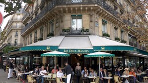 An outdoor cafe with tables and chairs, a waiter, and people dining. - ST GERMAIN, BALCONY, VIEW, 2 BATHS, 30–60 days ahead? Private offer. BEV-VBs (Paris)